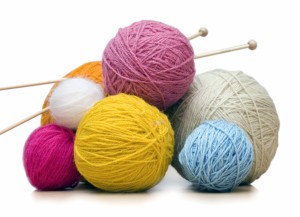 colorful yarn balls with needles